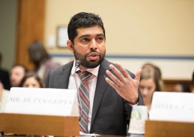 Indi-Dutta Gupta speaking on a panel before the House of Representatives Committee on Oversight and Reform. He is speaking and gesturing with his hands.