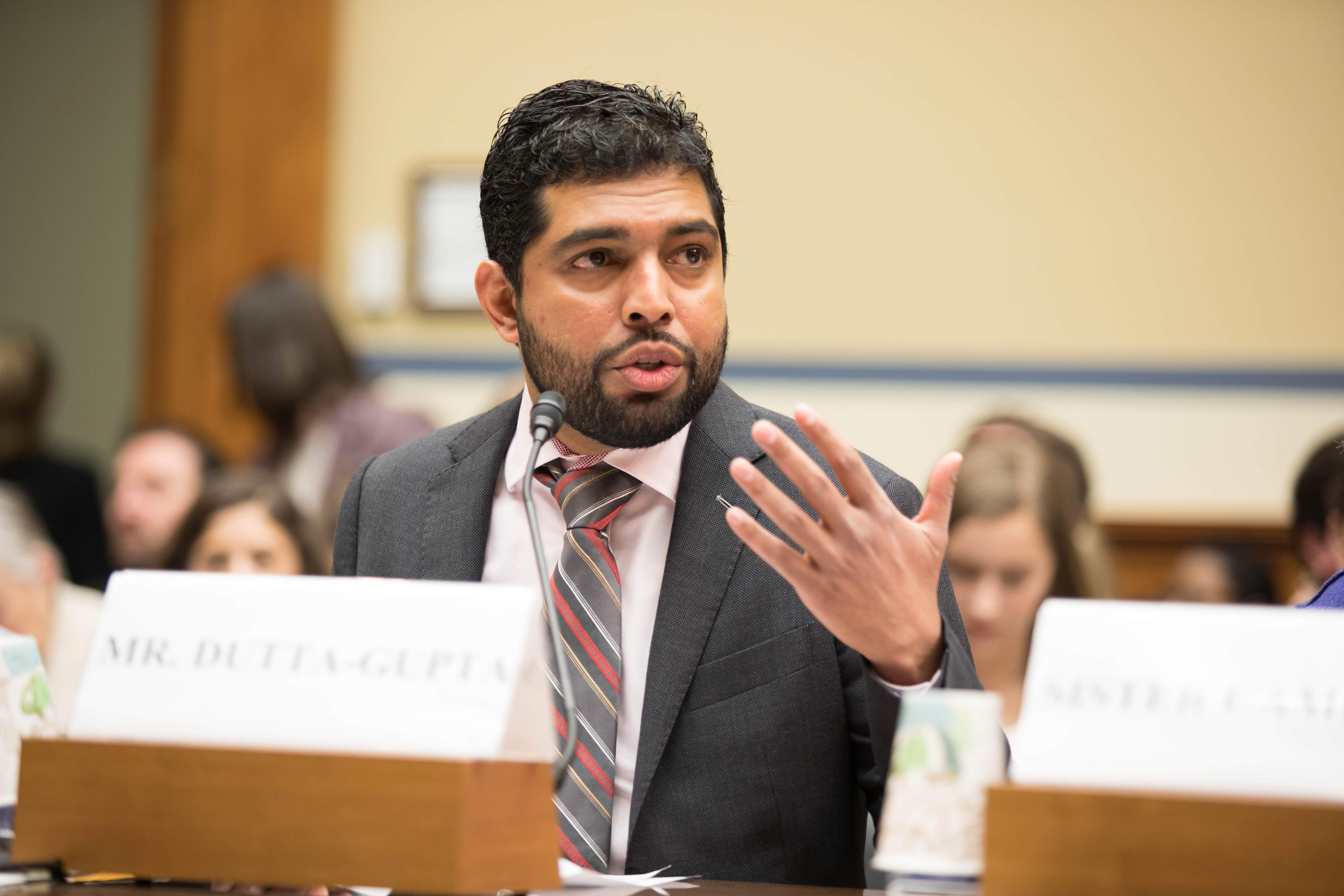 Indi-Dutta Gupta speaking on a panel before the House of Representatives Committee on Oversight and Reform. He is speaking and gesturing with his hands.