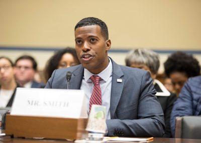 Rob Smith speaking on a panel before the House of Representatives Committee on Oversight and Reform. He is speaking and gesturing with his hands.